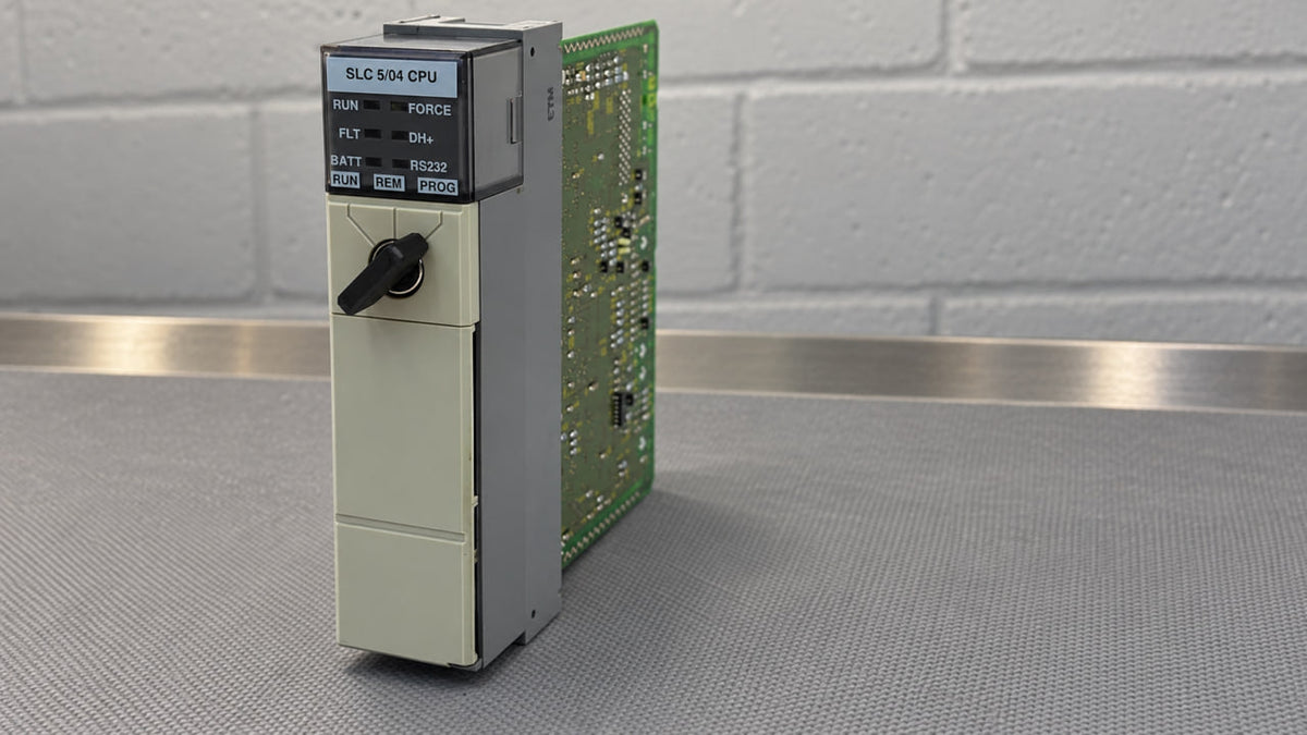Allen-Bradley 1747-L541 SLC 5/04 processor on a workbench, front view with status LEDs and keyswitch