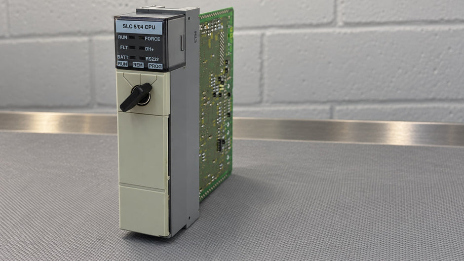 Allen-Bradley 1747-L541 SLC 5/04 processor on a workbench, front view with status LEDs and keyswitch