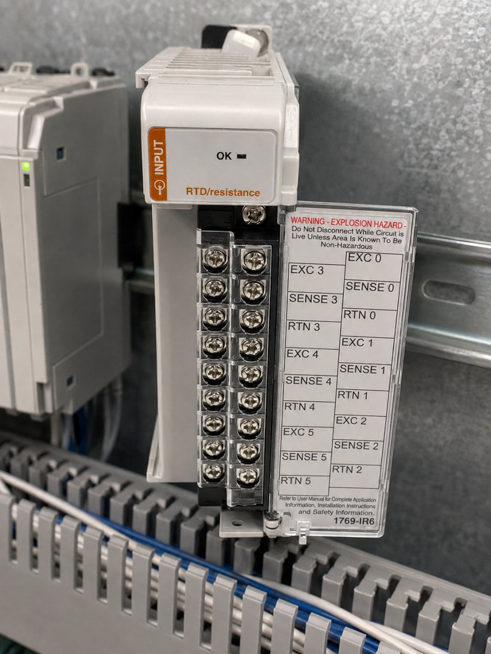 Allen-Bradley 1769-IR6 RTD input module mounted on a DIN rail in an open control cabinet